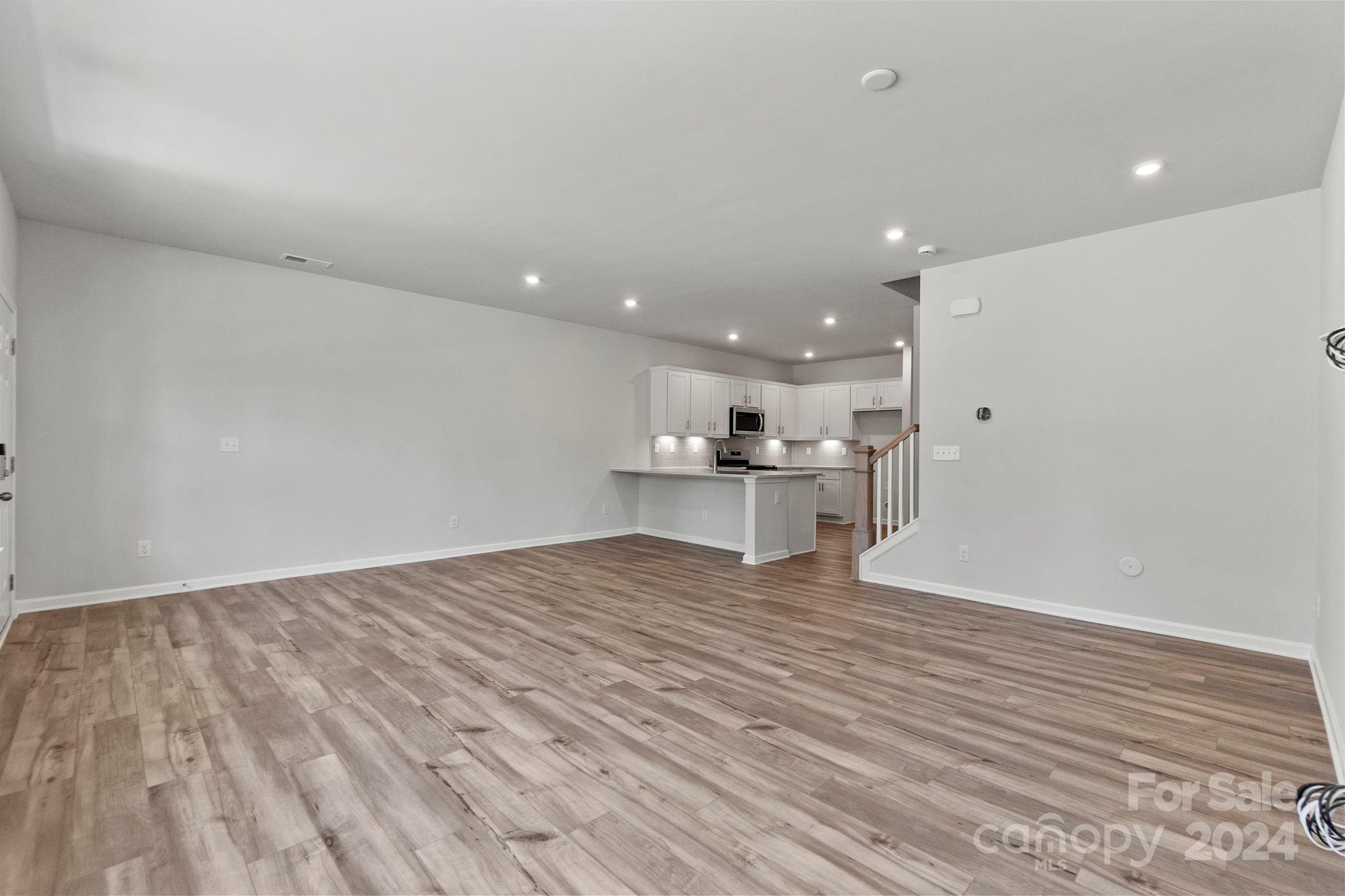 7864 Nelson Road Mint Hill, NC 28227 - Photo 21 of 45 a view of kitchen and empty room with wooden floor