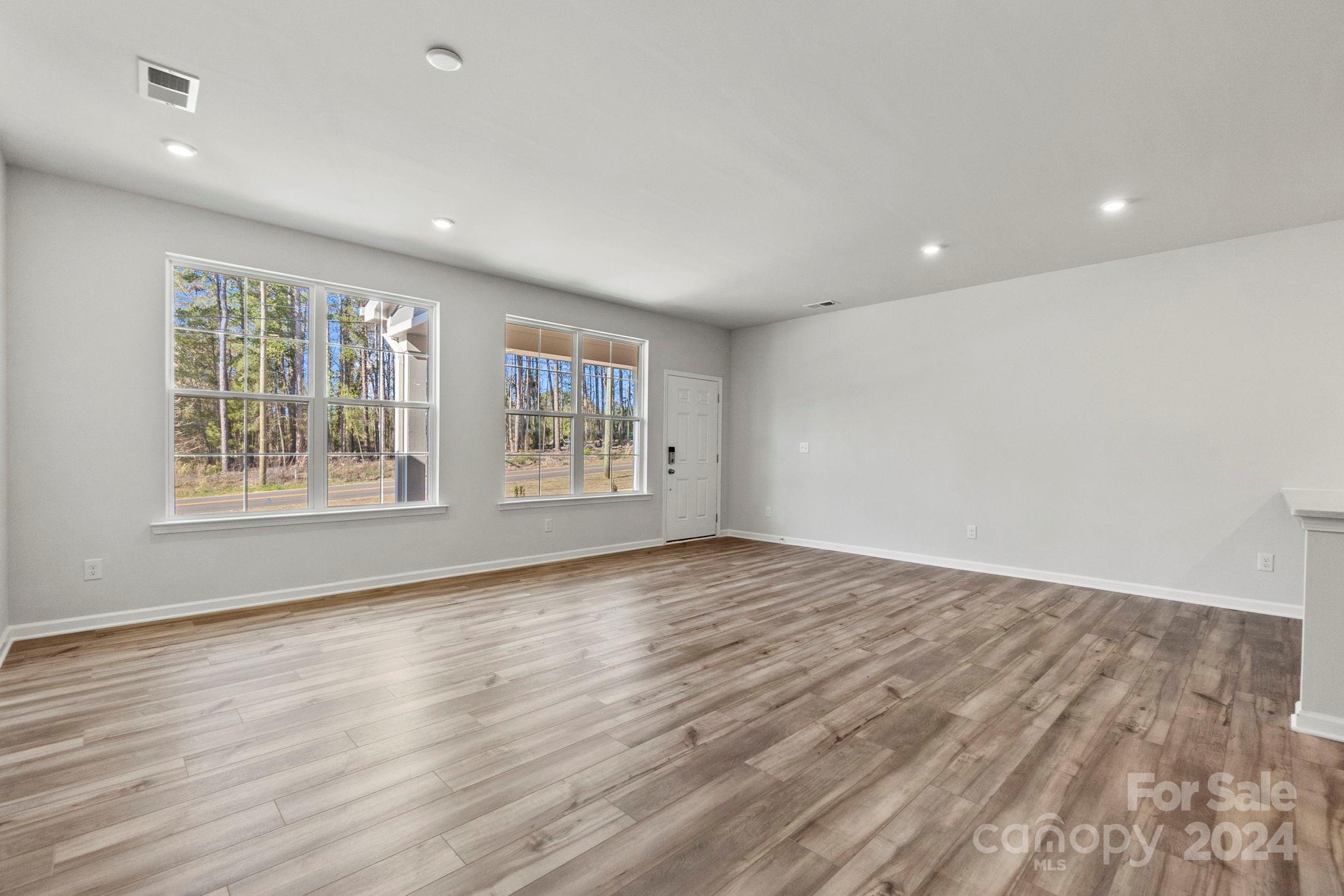 7864 Nelson Road Mint Hill, NC 28227 - Photo 22 of 45 an empty room with wooden floor and windows