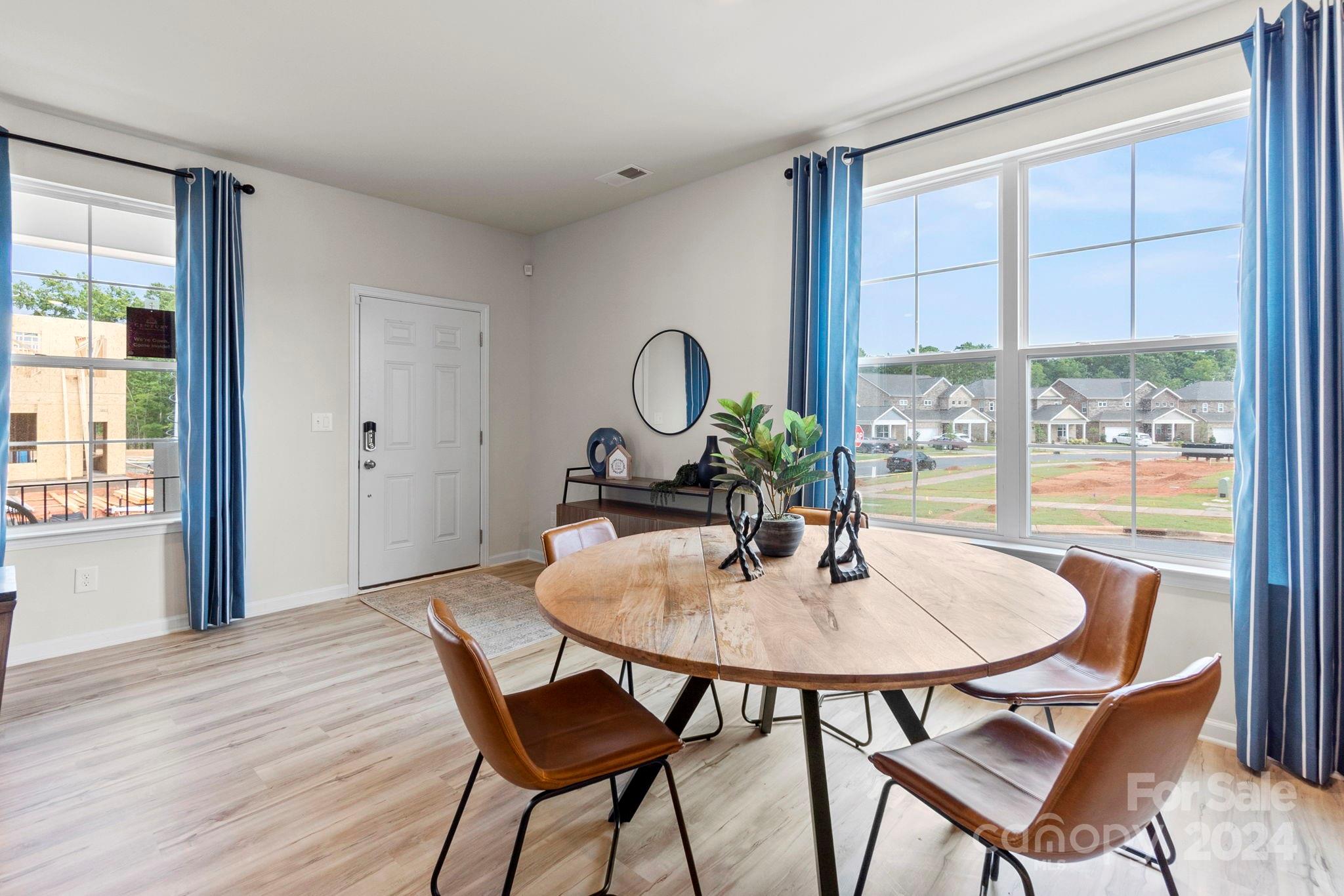 7864 Nelson Road Mint Hill, NC 28227 - Photo 3 of 45 a dining room with furniture and wooden floor