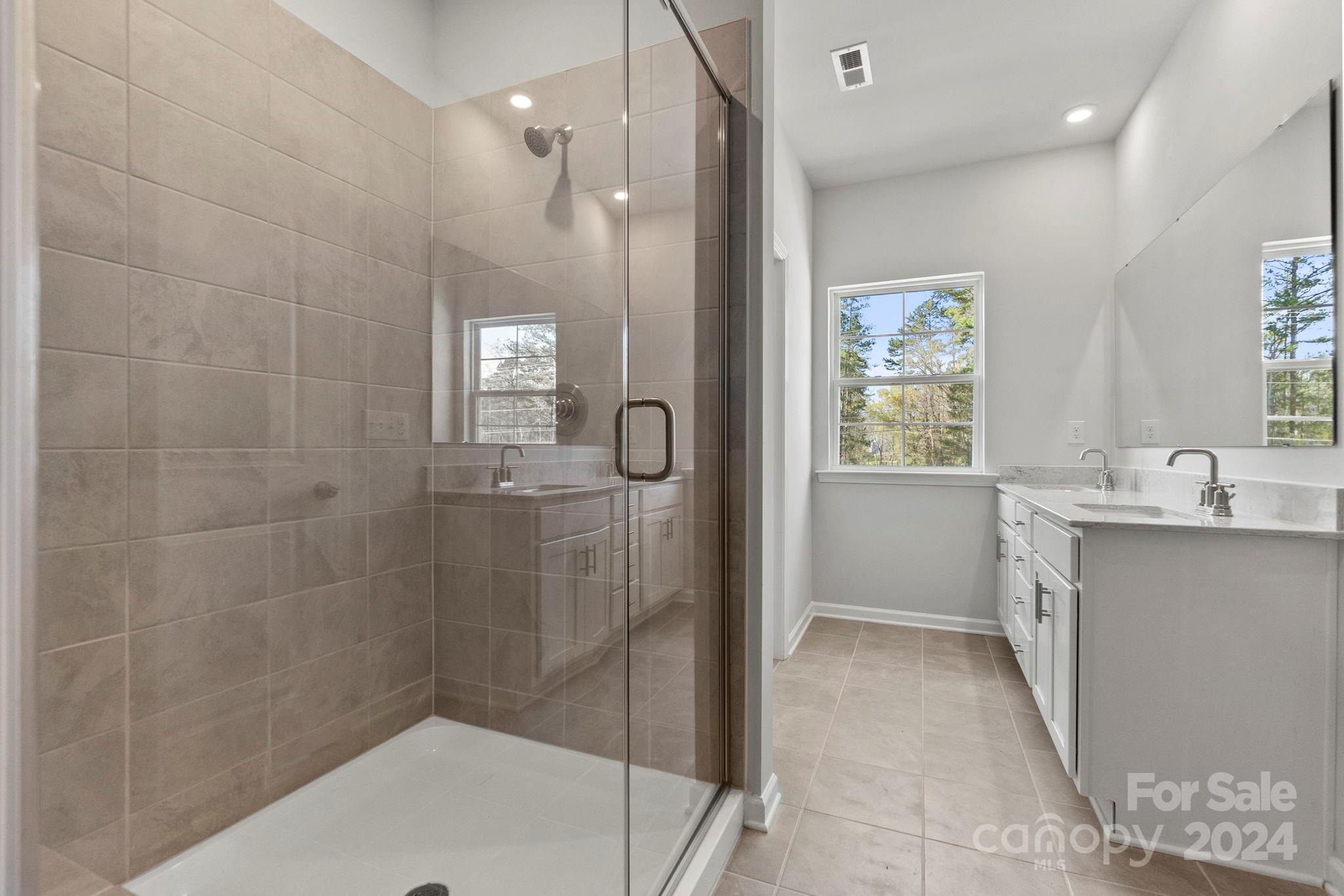 7864 Nelson Road Mint Hill, NC 28227 - Photo 33 of 45 a bathroom with a bathtub a shower a sink and mirror