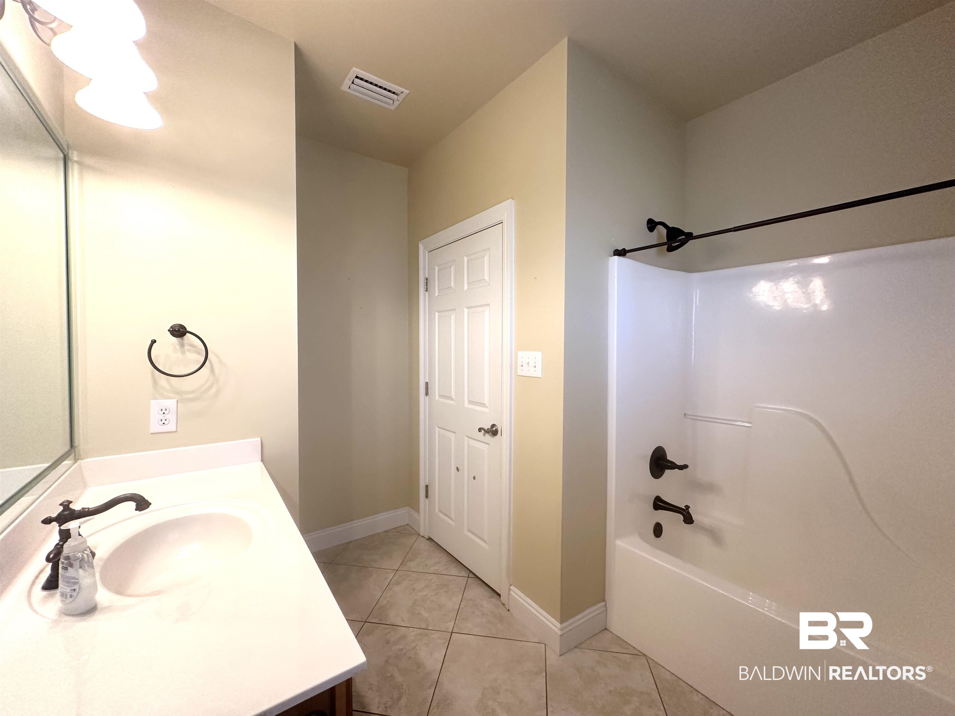 249 Hemingway Loop Foley, AL 36535 - Photo 17 of 33 Bathroom featuring vanity, shower / bathing tub combination, and tile patterned flooring