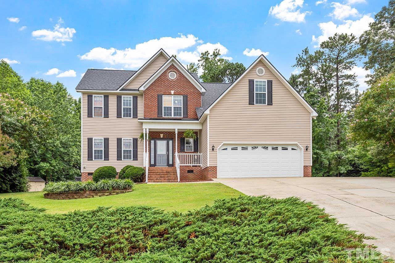a view of a house with garden and yard