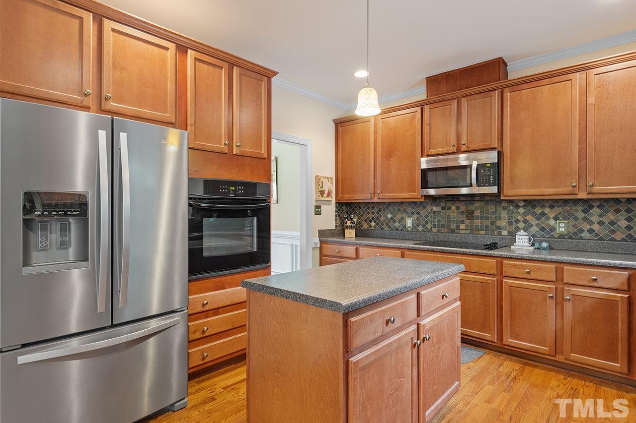 206 Kendall Drive Clayton, NC 27520 - Photo 14 of 34 a kitchen with stainless steel appliances granite countertop a refrigerator sink and microwave