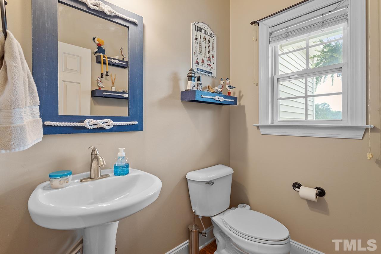 206 Kendall Drive Clayton, NC 27520 - Photo 15 of 34 a bathroom with a toilet sink and mirror