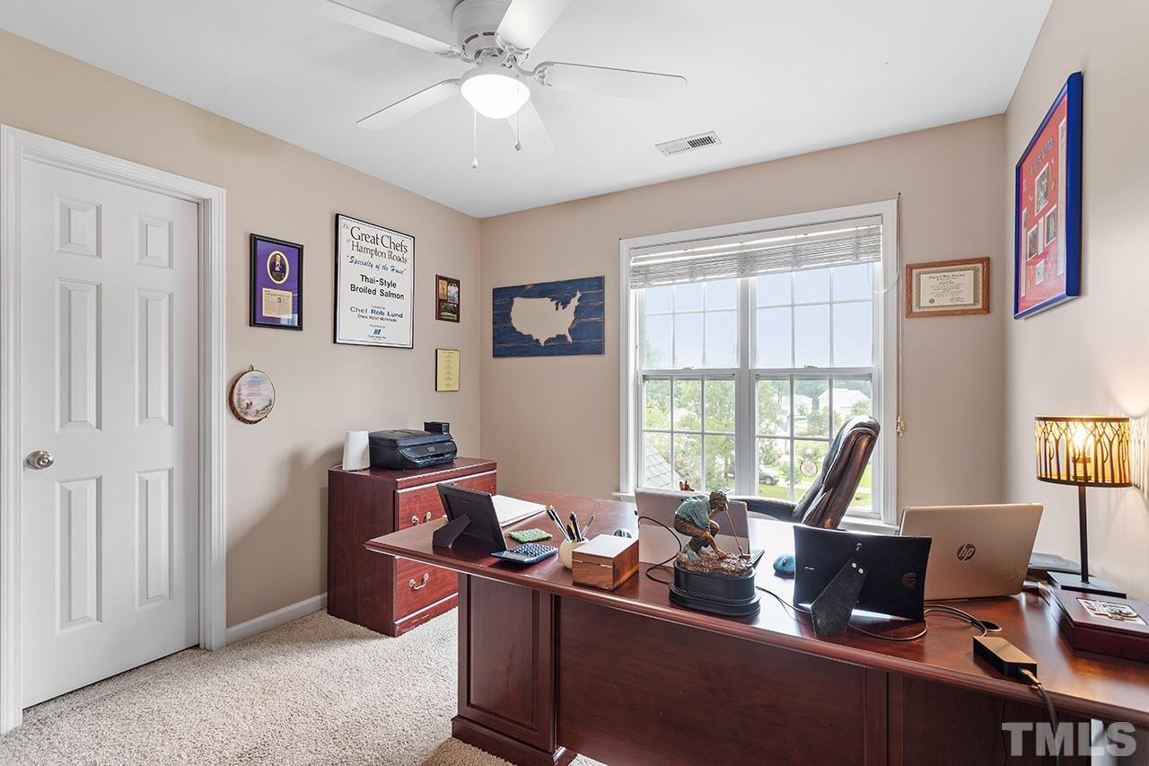 206 Kendall Drive Clayton, NC 27520 - Photo 20 of 34 a living room with furniture two window and a flat screen tv