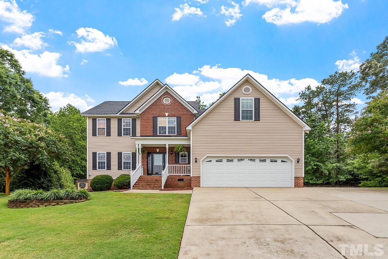 206 Kendall Drive Clayton, NC 27520 - Photo 2 of 34 a front view of a house with a yard and garage