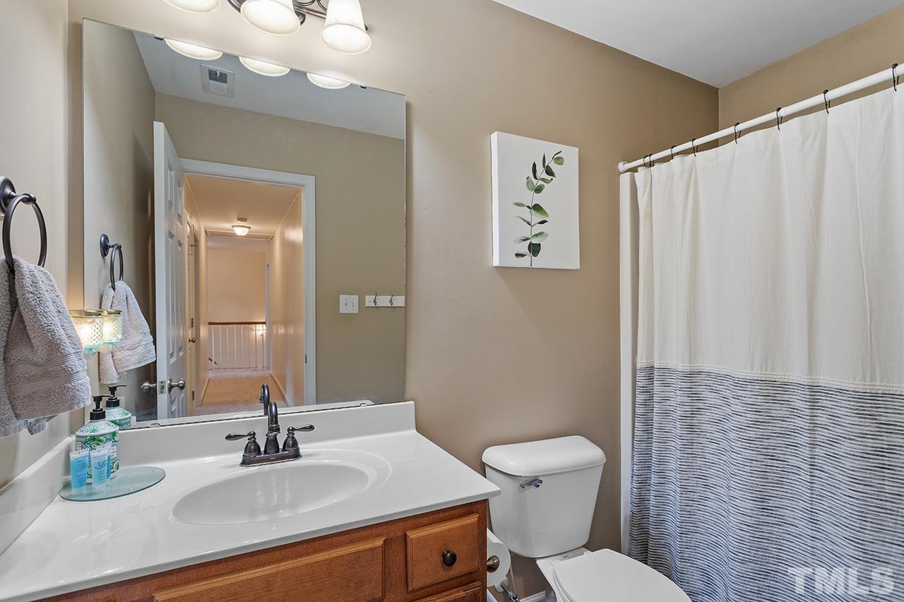 206 Kendall Drive Clayton, NC 27520 - Photo 21 of 34 a bathroom with a sink a toilet and shower curtain