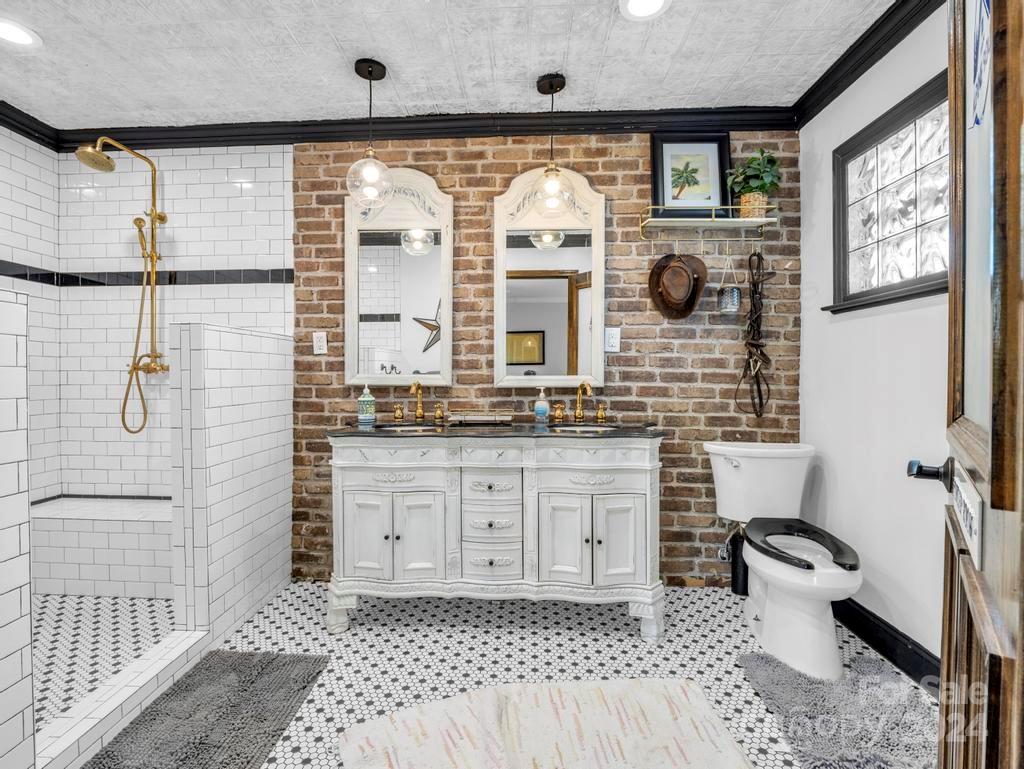206 Hooker Road Tryon, NC 28782 - Photo 16 of 46 a bathroom with a granite countertop sink mirror vanity and toilet