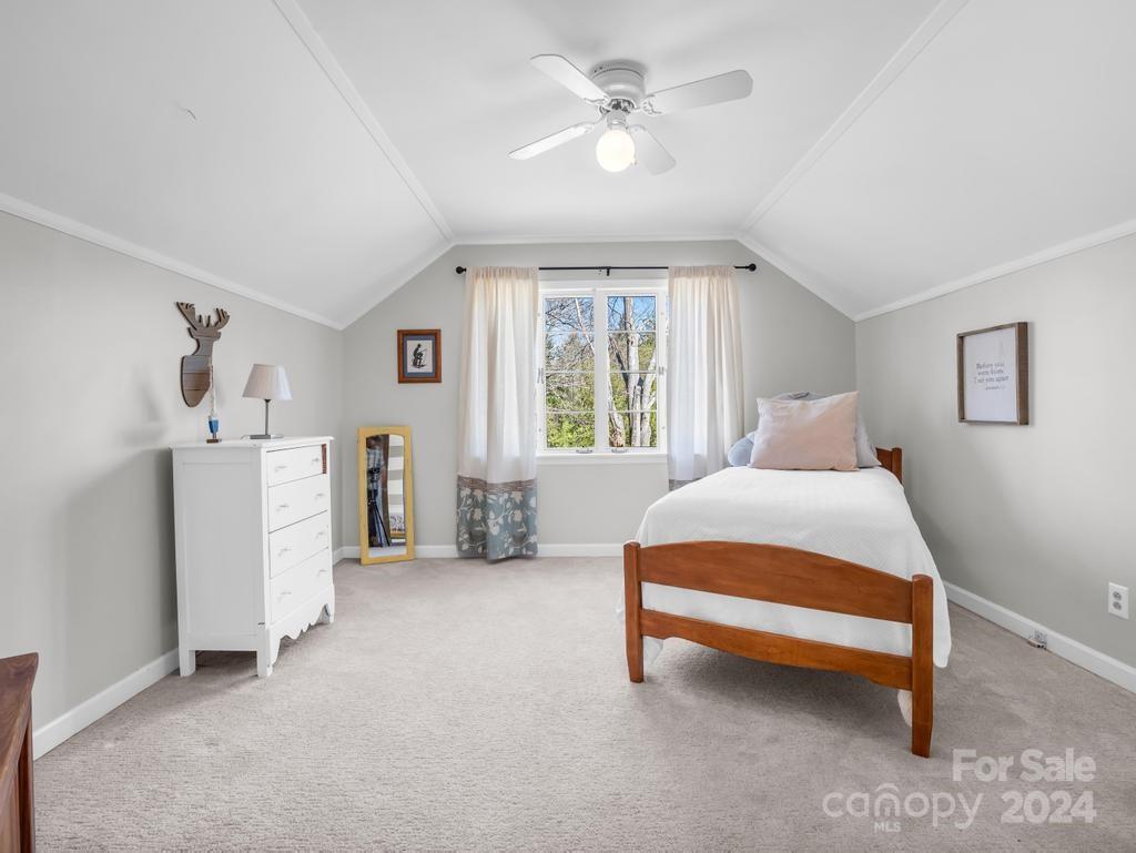 206 Hooker Road Tryon, NC 28782 - Photo 34 of 46 a bedroom with a bed and a chandelier