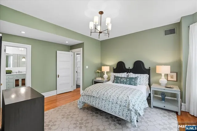 a bedroom with a bed and a chandelier