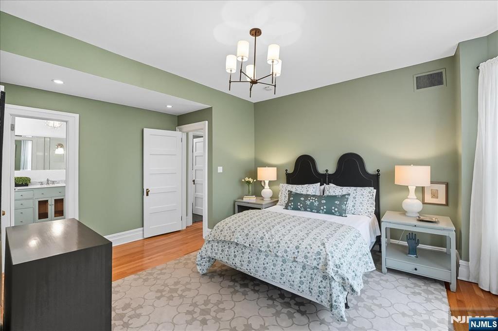 56-58 Bonn Place Weehawken, NJ 07086 - Photo 12 of 29 a bedroom with a bed and a chandelier