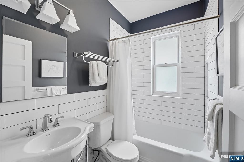 56-58 Bonn Place Weehawken, NJ 07086 - Photo 17 of 29 a bathroom with a sink toilet and shower