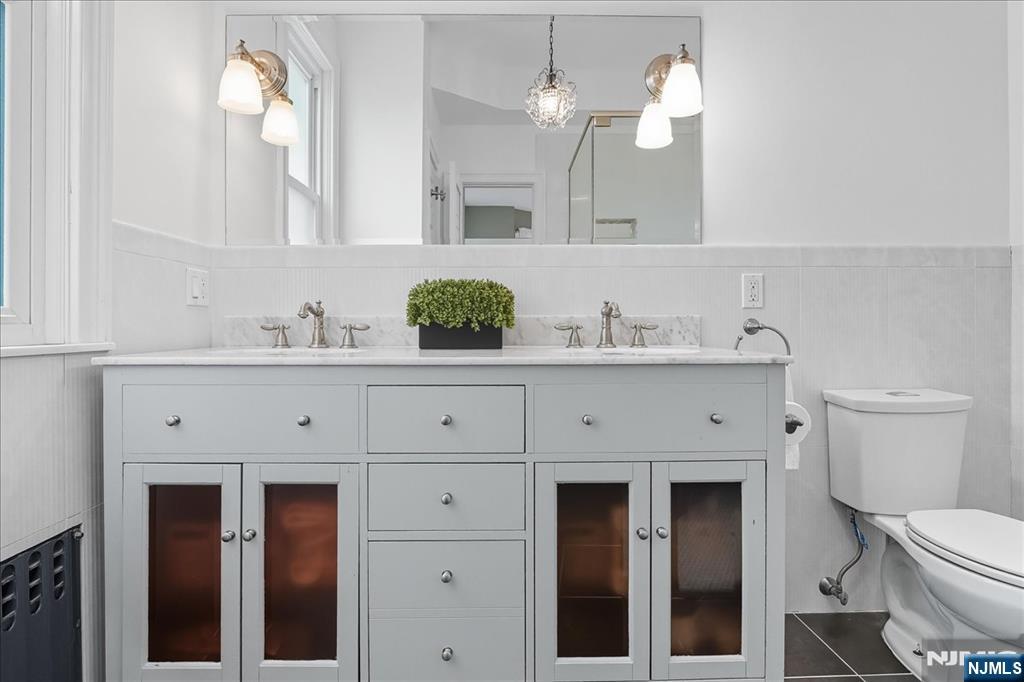 56-58 Bonn Place Weehawken, NJ 07086 - Photo 18 of 29 a bathroom with a sink and a mirror