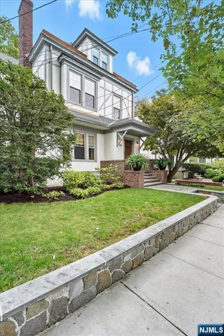 a front view of a house with a yard table and chairs