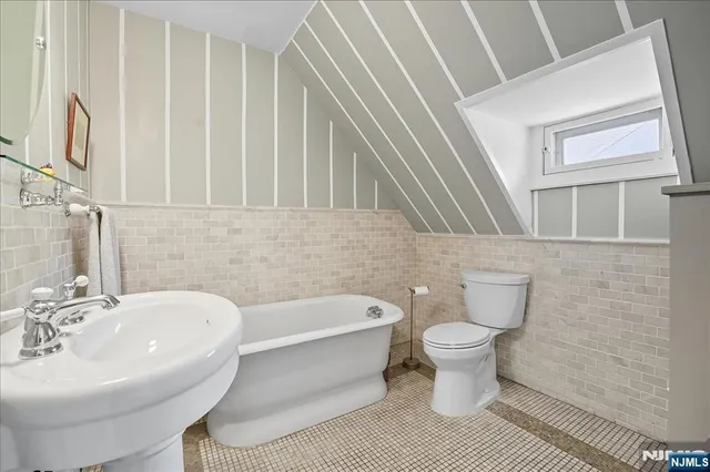a bathroom with a white toilet sitting next to a white sink