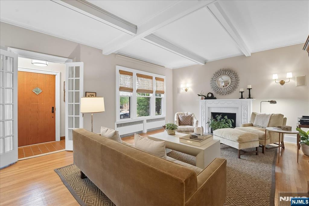 56-58 Bonn Place Weehawken, NJ 07086 - Photo 6 of 29 a living room with furniture and a fireplace