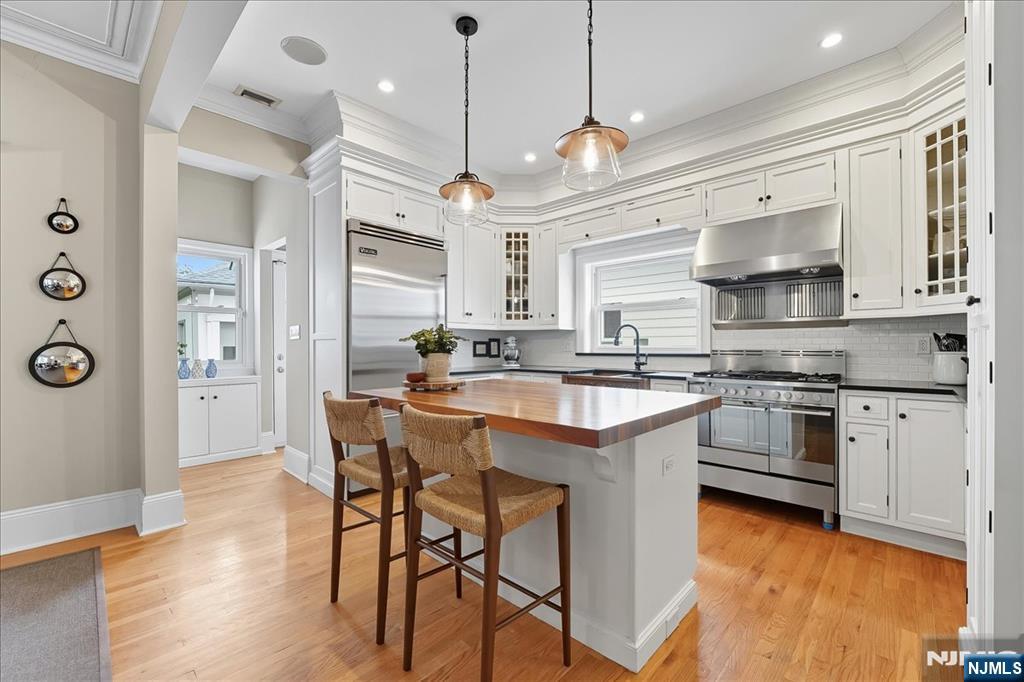 56-58 Bonn Place Weehawken, NJ 07086 - Photo 9 of 29 a kitchen with stainless steel appliances granite countertop a stove a sink and a refrigerator