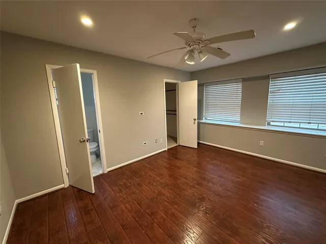 a bathroom with a granite countertop sink toilet and a mirror