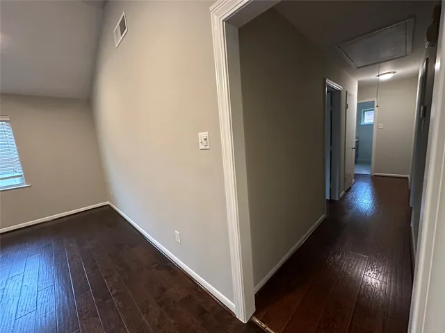 a view of hallway with wooden floor