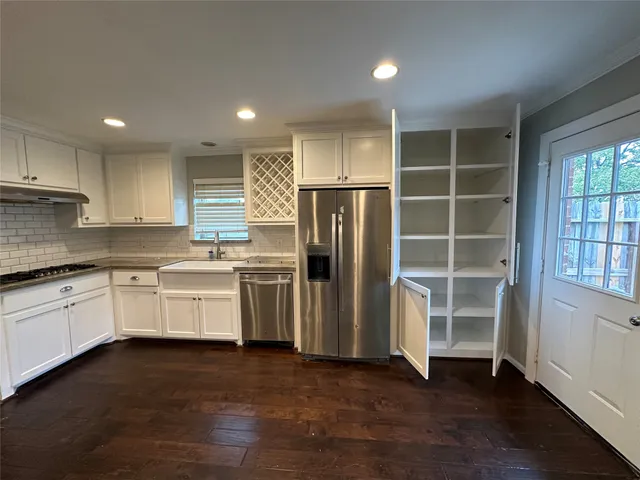 a kitchen with a refrigerator and a sink
