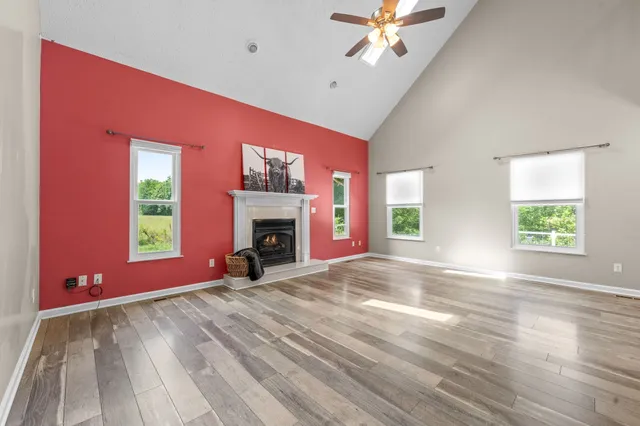 a view of empty room with window and fireplace