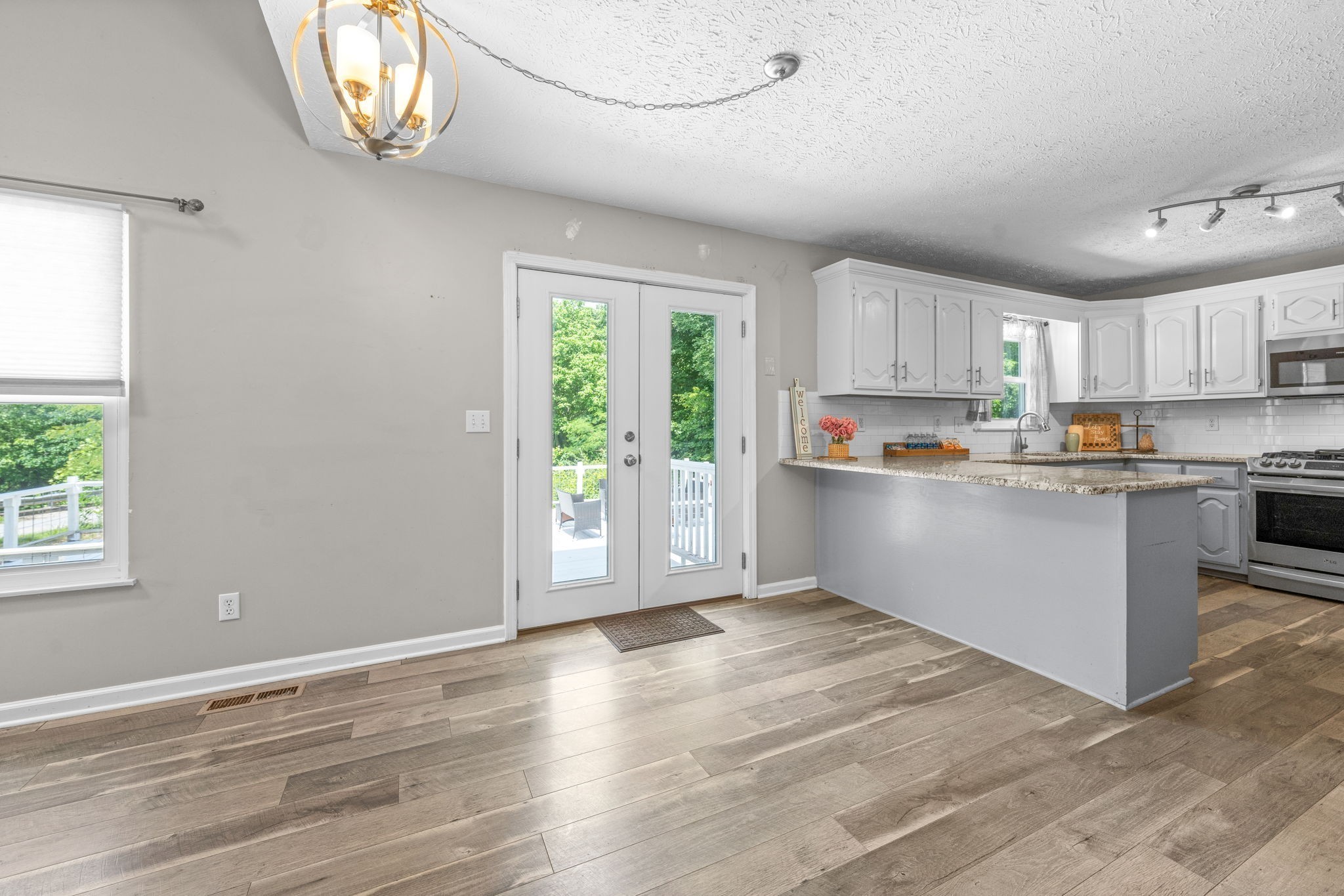 4178 Highway 49 Tennessee Ridge, TN 37178 - Photo 14 of 38 a view of kitchen with wooden floor and window
