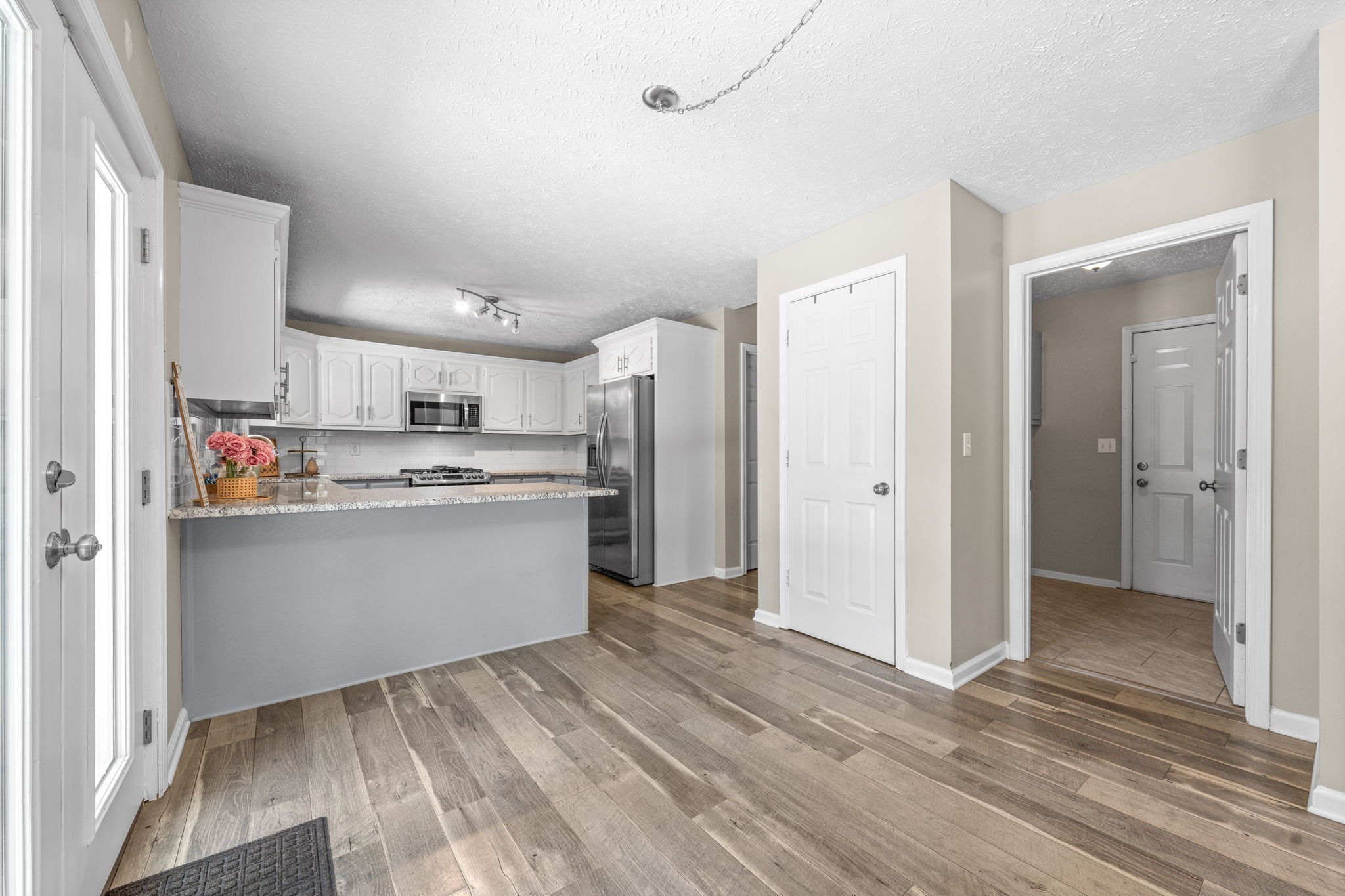4178 Highway 49 Tennessee Ridge, TN 37178 - Photo 15 of 38 a view of a kitchen with refrigerator and white cabinets