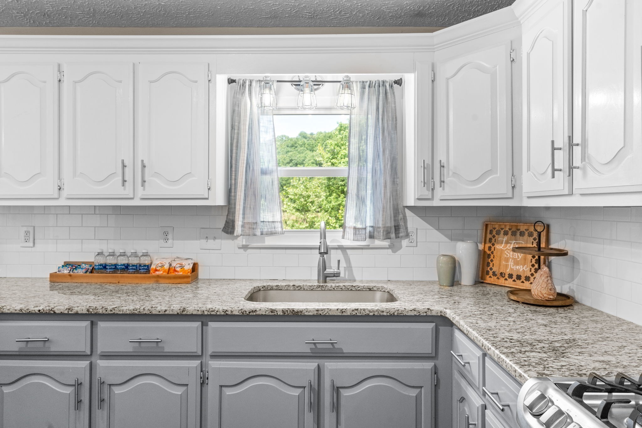 4178 Highway 49 Tennessee Ridge, TN 37178 - Photo 19 of 38 a kitchen with granite countertop white cabinets and a window