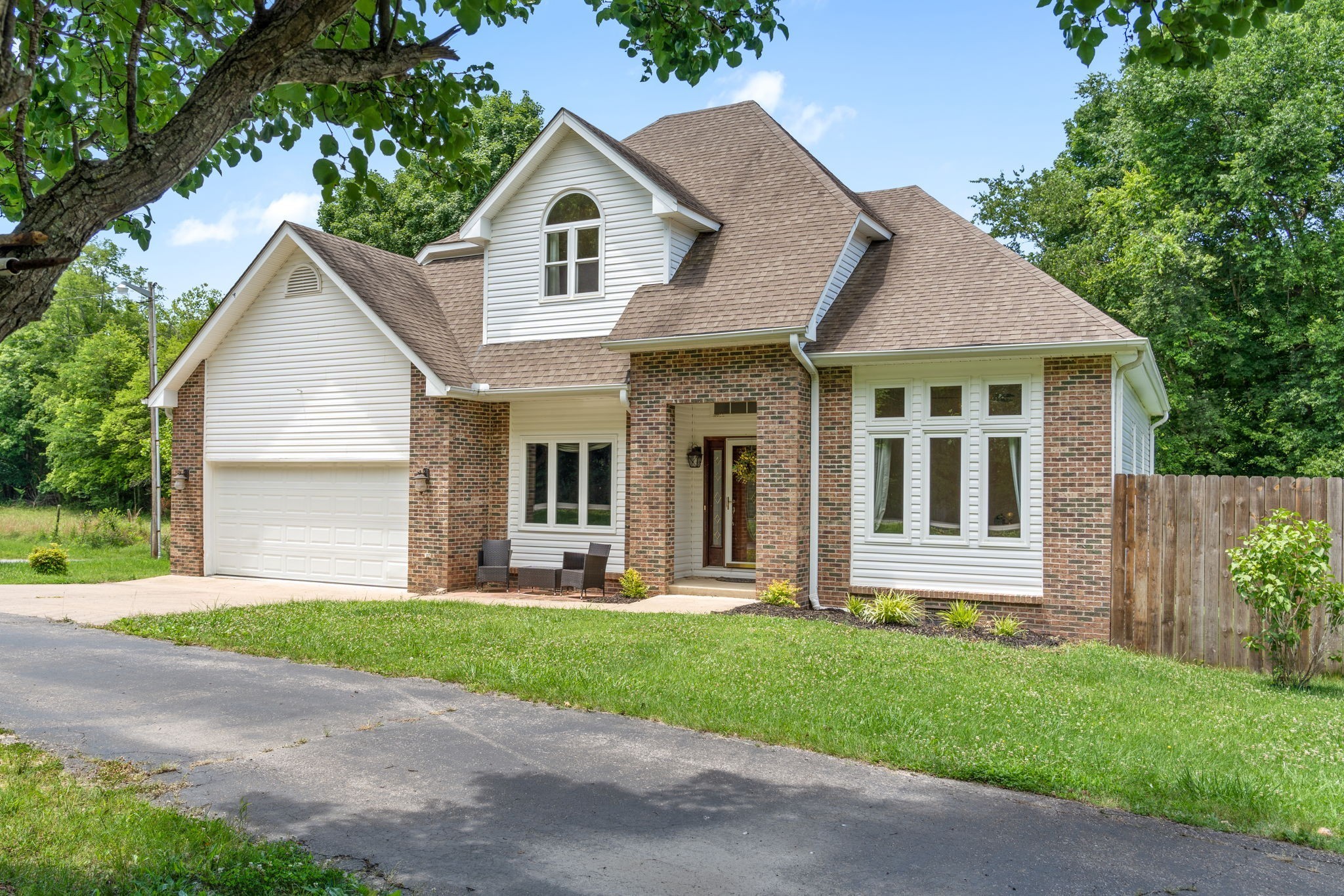 4178 Highway 49 Tennessee Ridge, TN 37178 - Photo 2 of 38 a front view of a house with a yard and an outdoor view