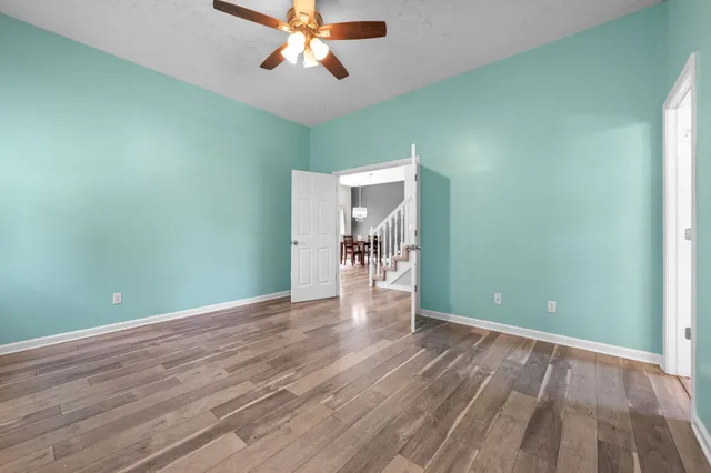 wooden floor in an empty room with a window