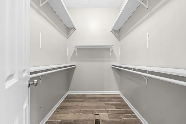 a view of walk in closet with empty racks