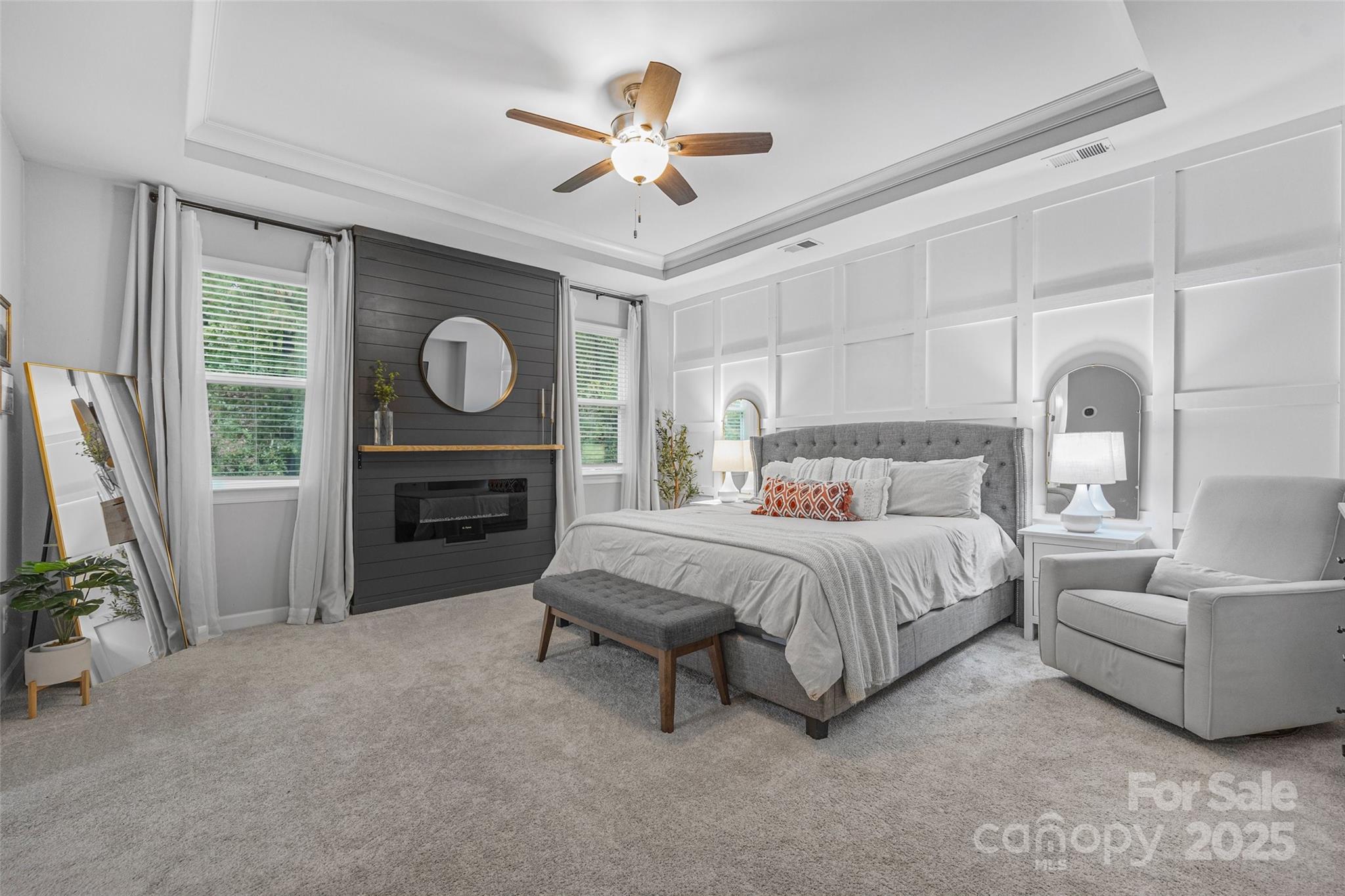 451 Sandbar Point Clover, SC 29710 - Photo 18 of 34 a spacious bedroom with a bed a fireplace and a chandelier