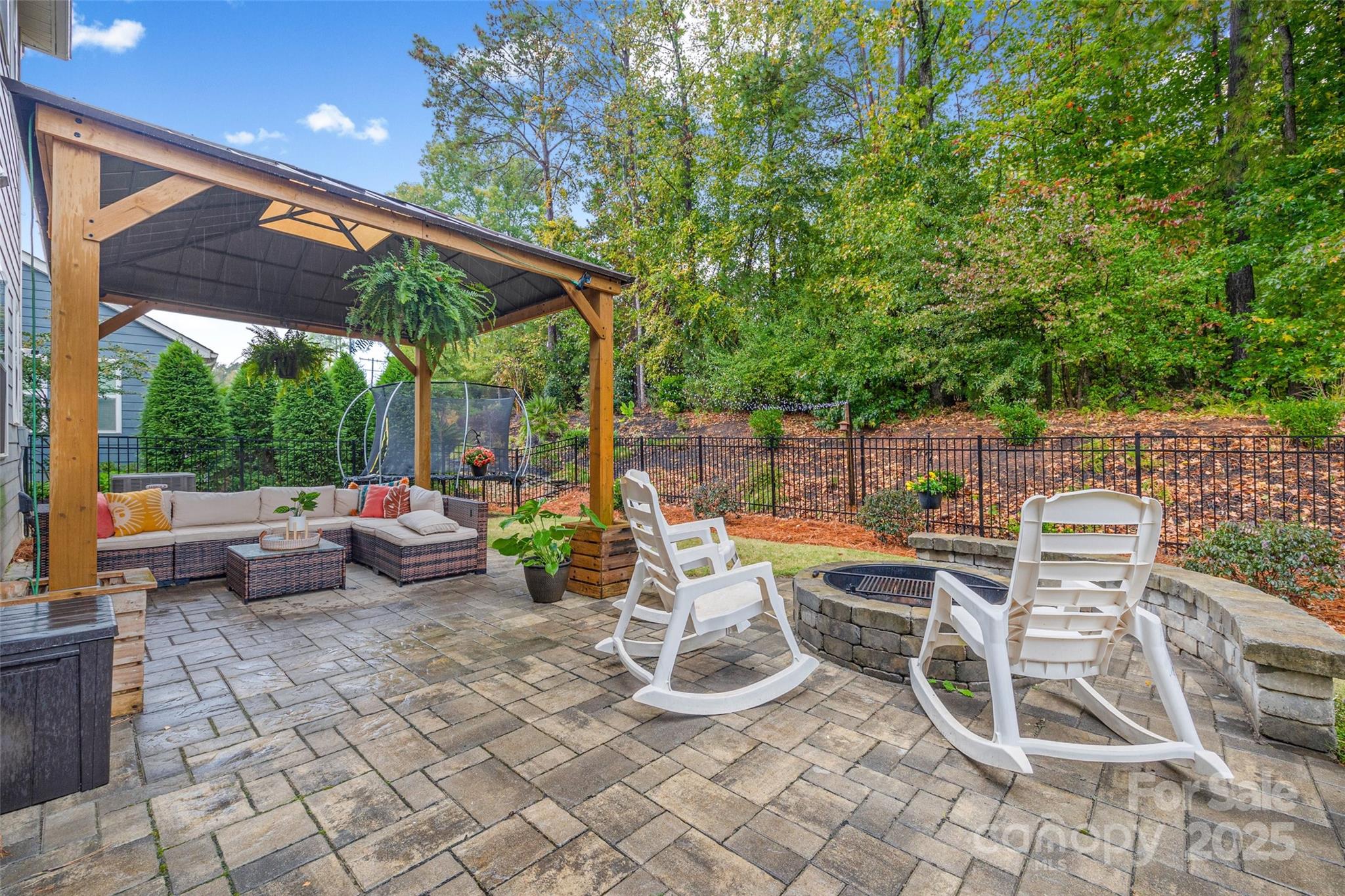 451 Sandbar Point Clover, SC 29710 - Photo 29 of 34 a view of a patio with a dining table and chairs with wooden floor and fence