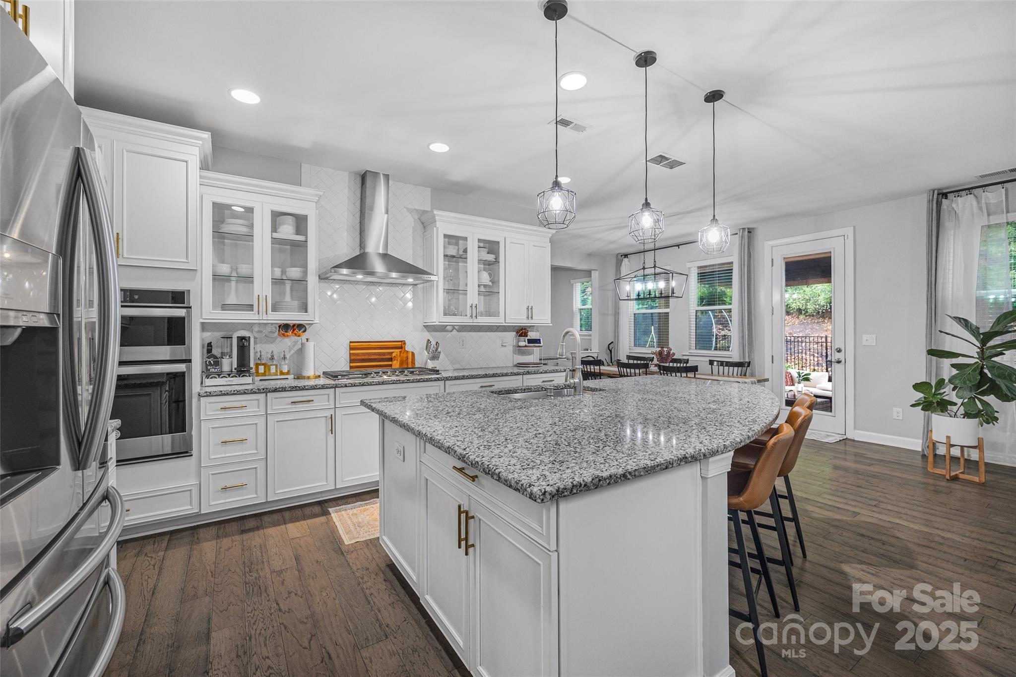 451 Sandbar Point Clover, SC 29710 - Photo 8 of 34 a kitchen with stainless steel appliances granite countertop a kitchen island a stove and a sink