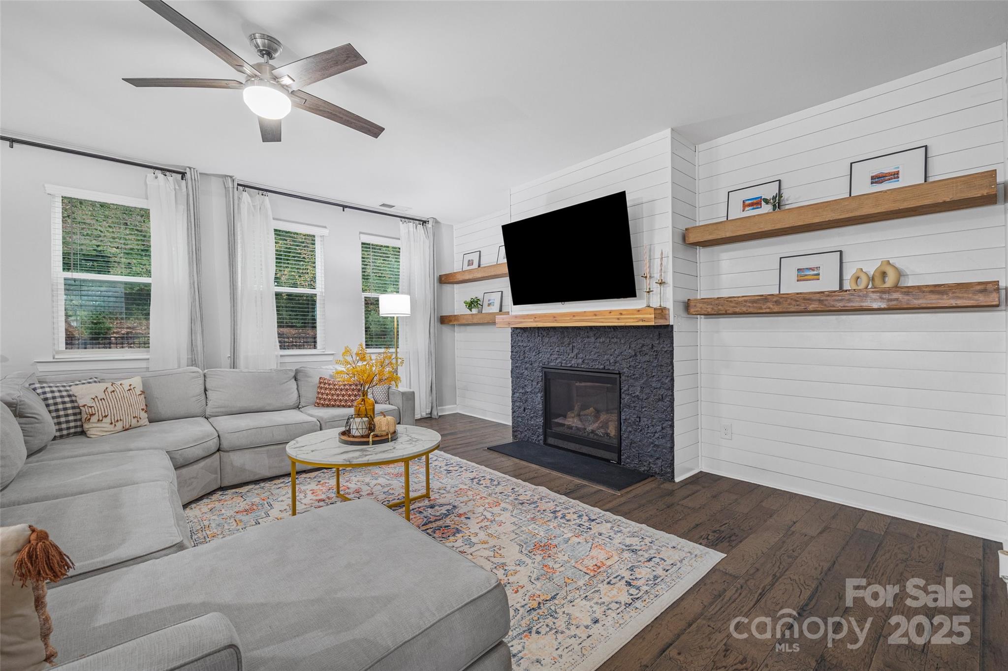 451 Sandbar Point Clover, SC 29710 - Photo 9 of 34 a living room with furniture a fireplace and a flat screen tv