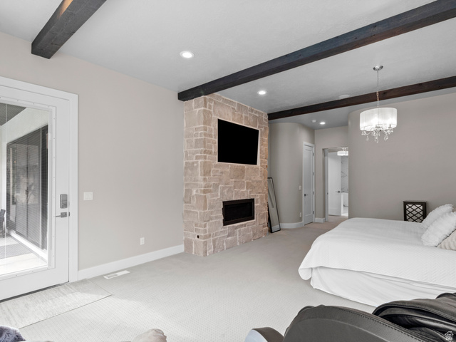 614 East High Lane Alpine, UT 84004 - Photo 43 of 75 Bedroom featuring beamed ceiling, carpet, a stone fireplace, access to outside, and hanging lights