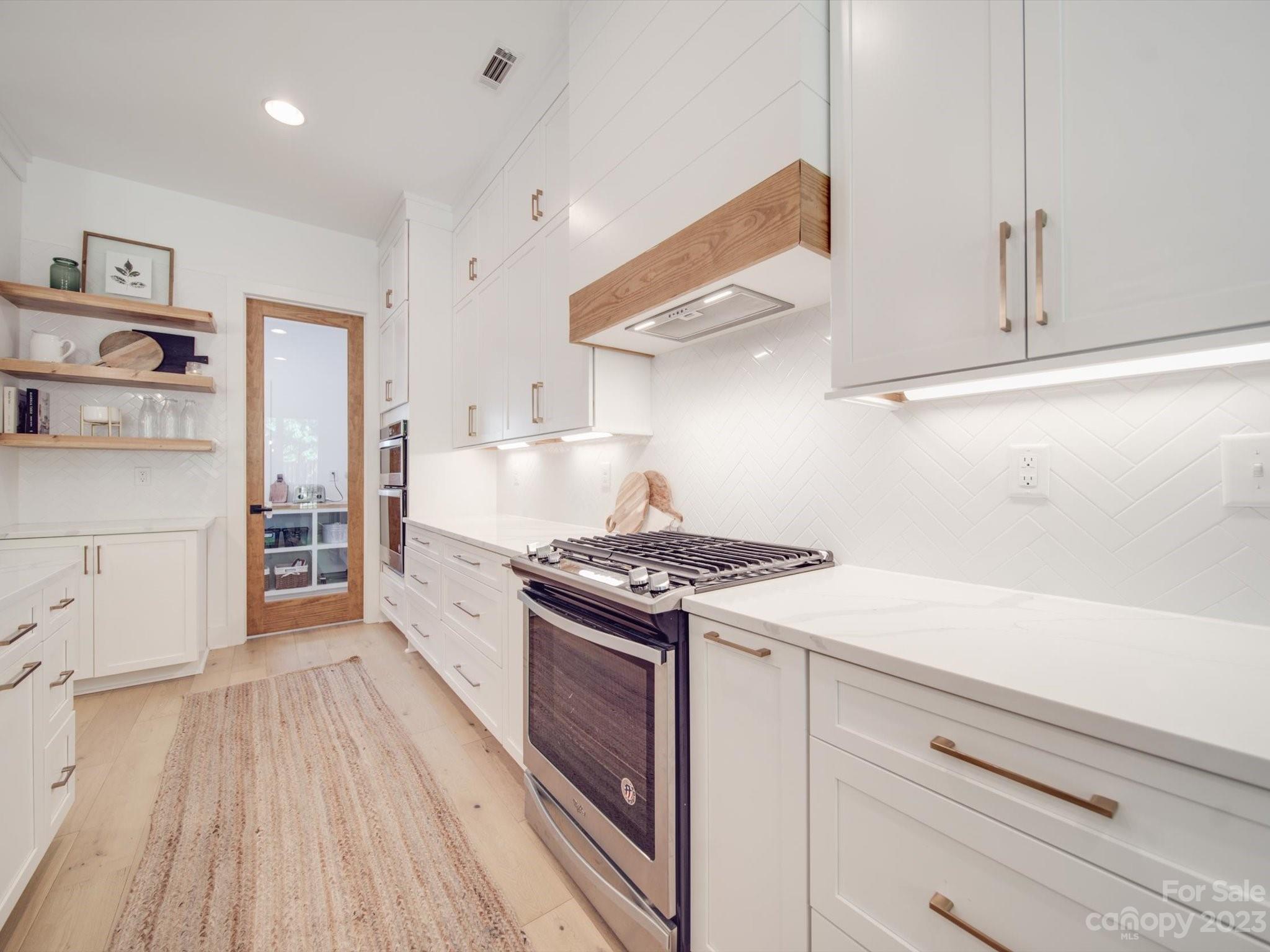 626 Deese Road Monroe, NC 28110 - Photo 15 of 41 a kitchen with stainless steel appliances granite countertop a stove and a refrigerator