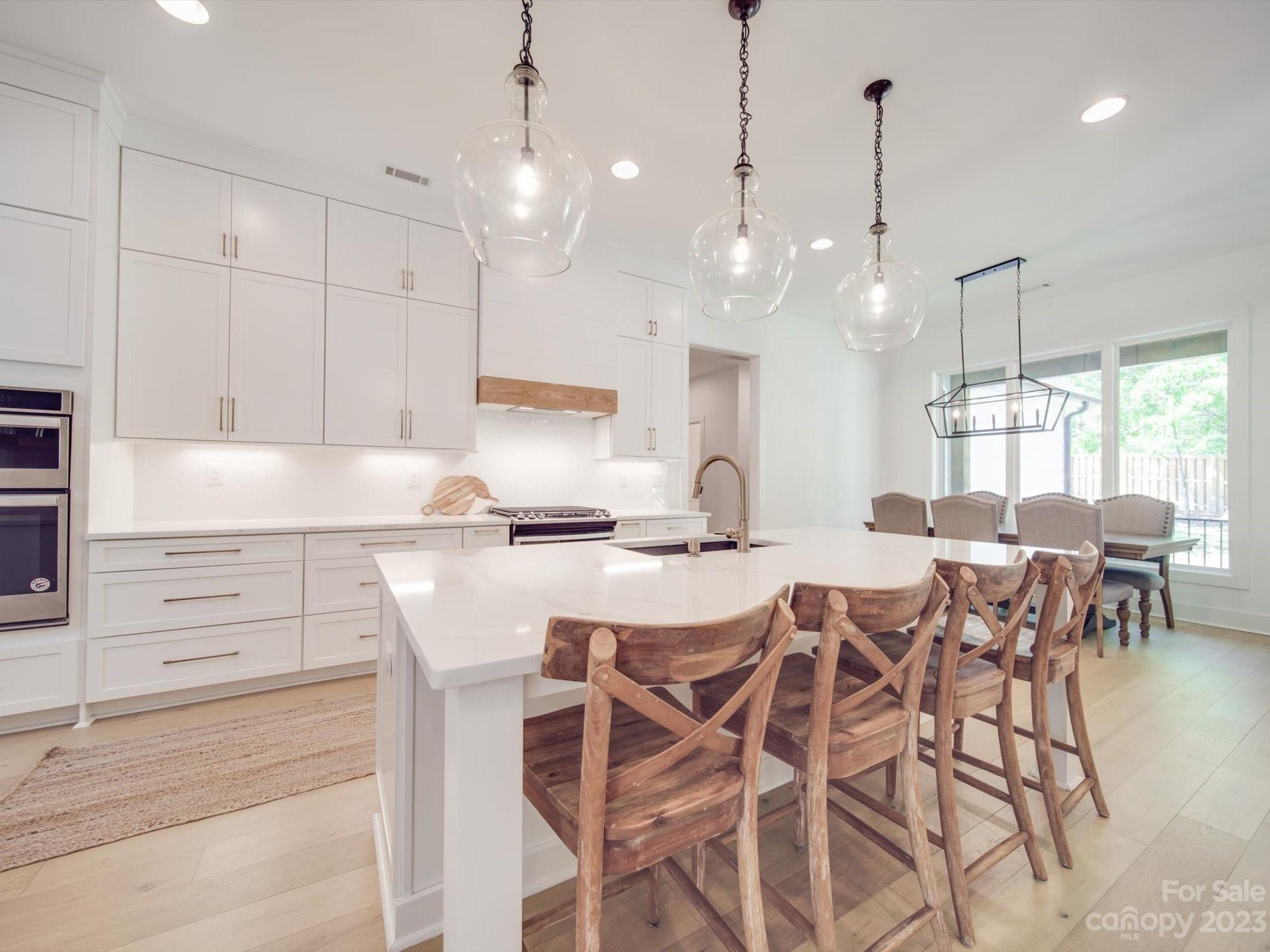 626 Deese Road Monroe, NC 28110 - Photo 19 of 41 a kitchen with a table chairs stove and cabinets