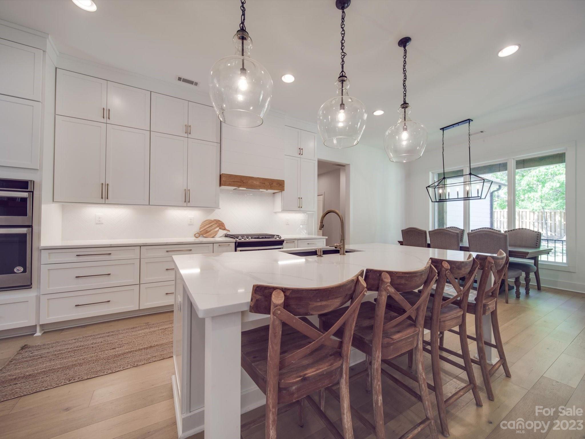 626 Deese Road Monroe, NC 28110 - Photo 20 of 41 a kitchen with a table chairs and white cabinets