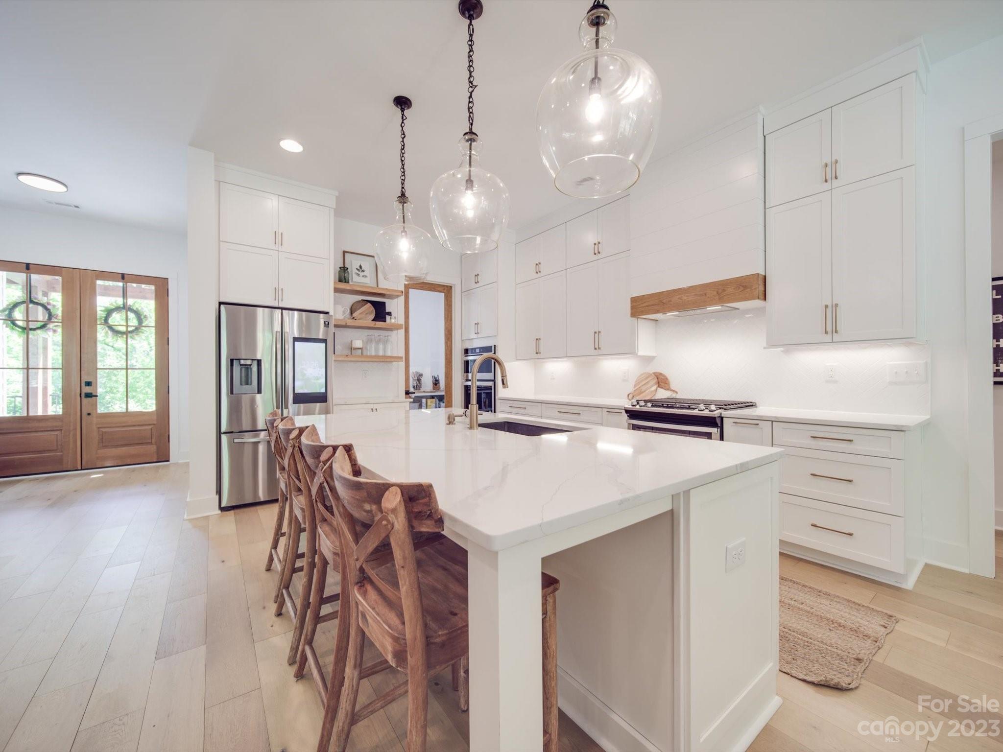 626 Deese Road Monroe, NC 28110 - Photo 21 of 41 a kitchen with stainless steel appliances kitchen island granite countertop a table chairs refrigerator and microwave