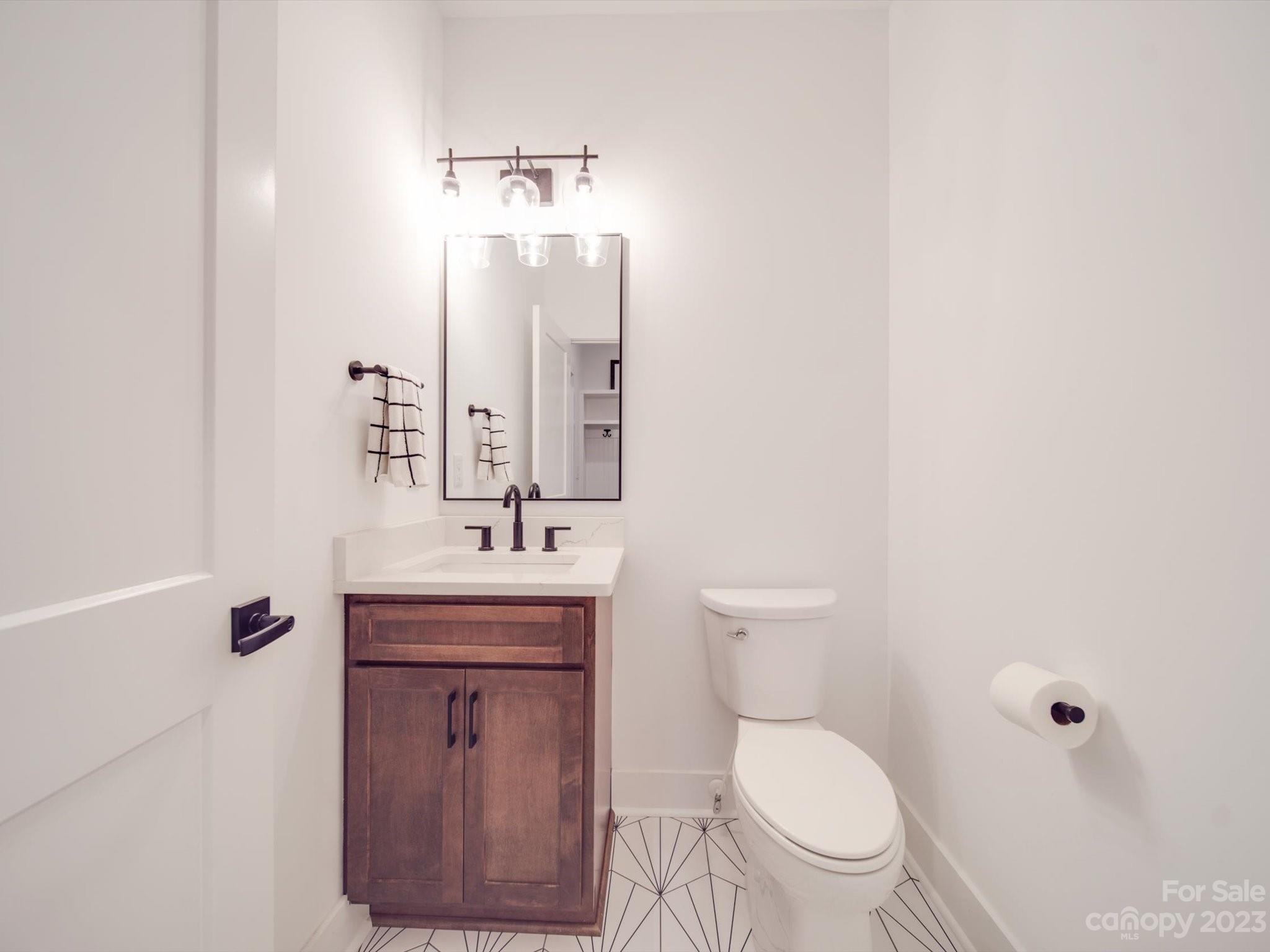 626 Deese Road Monroe, NC 28110 - Photo 32 of 41 a bathroom with a toilet a sink and mirror