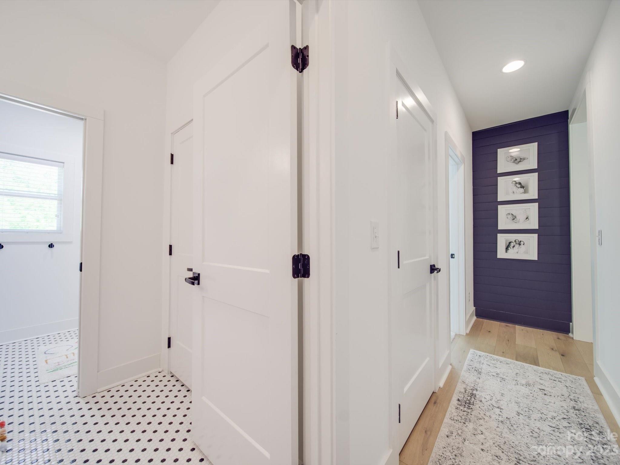 626 Deese Road Monroe, NC 28110 - Photo 35 of 41 a view of a hallway with wooden floor and a bathroom