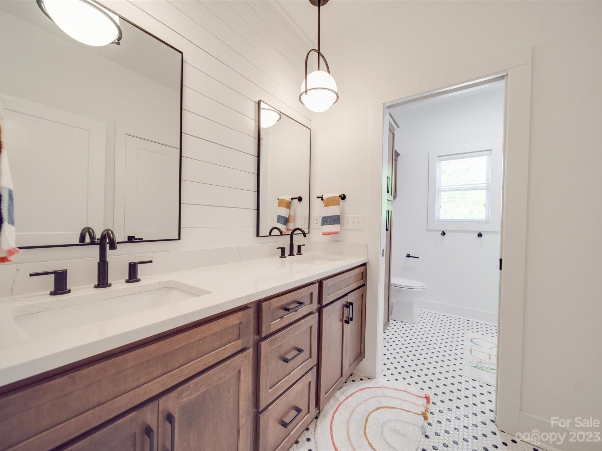 626 Deese Road Monroe, NC 28110 - Photo 36 of 41 a spacious bathroom with a double vanity sink a mirror and a shower