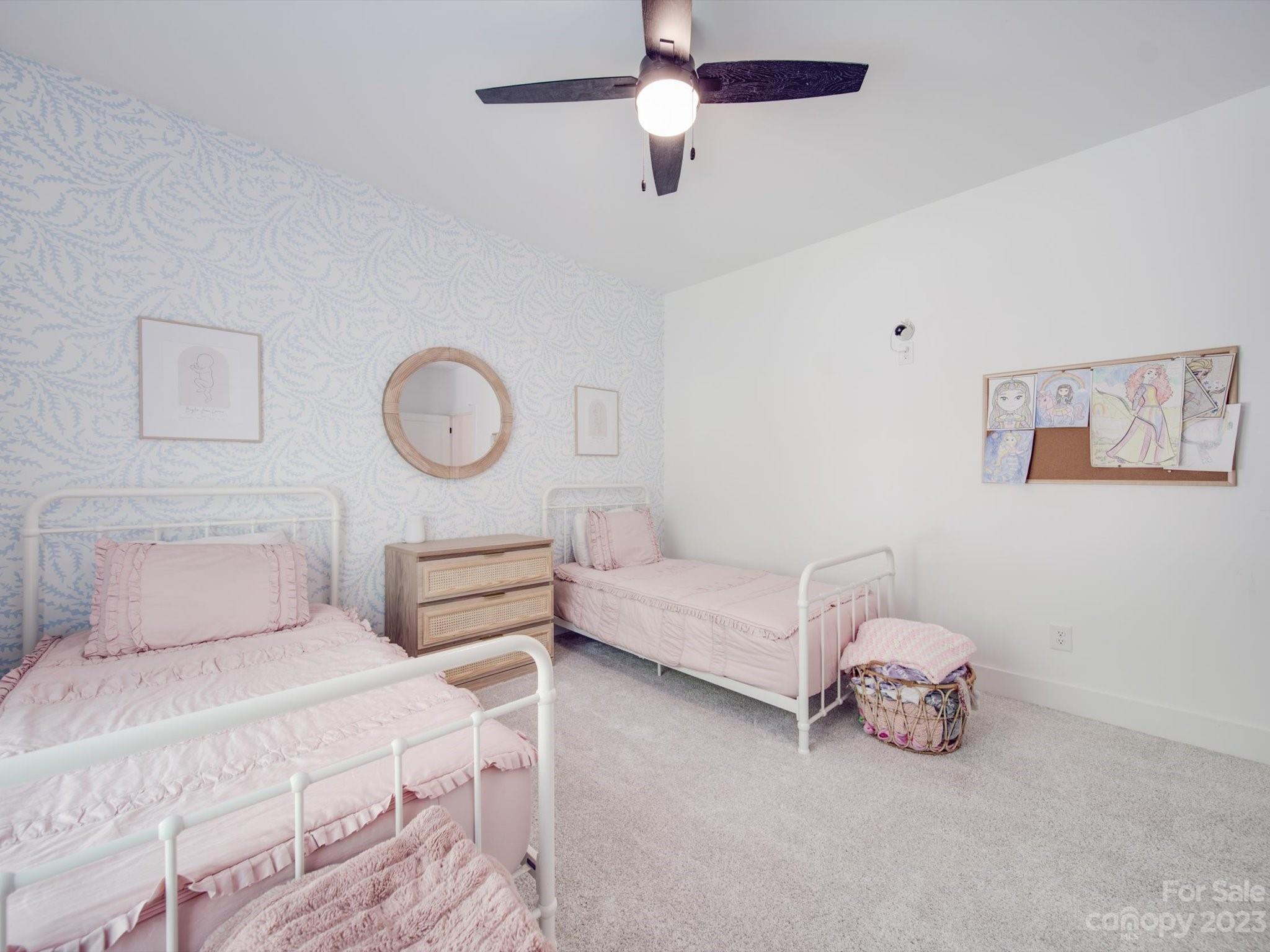 626 Deese Road Monroe, NC 28110 - Photo 38 of 41 a bedroom with a bed and a chandelier