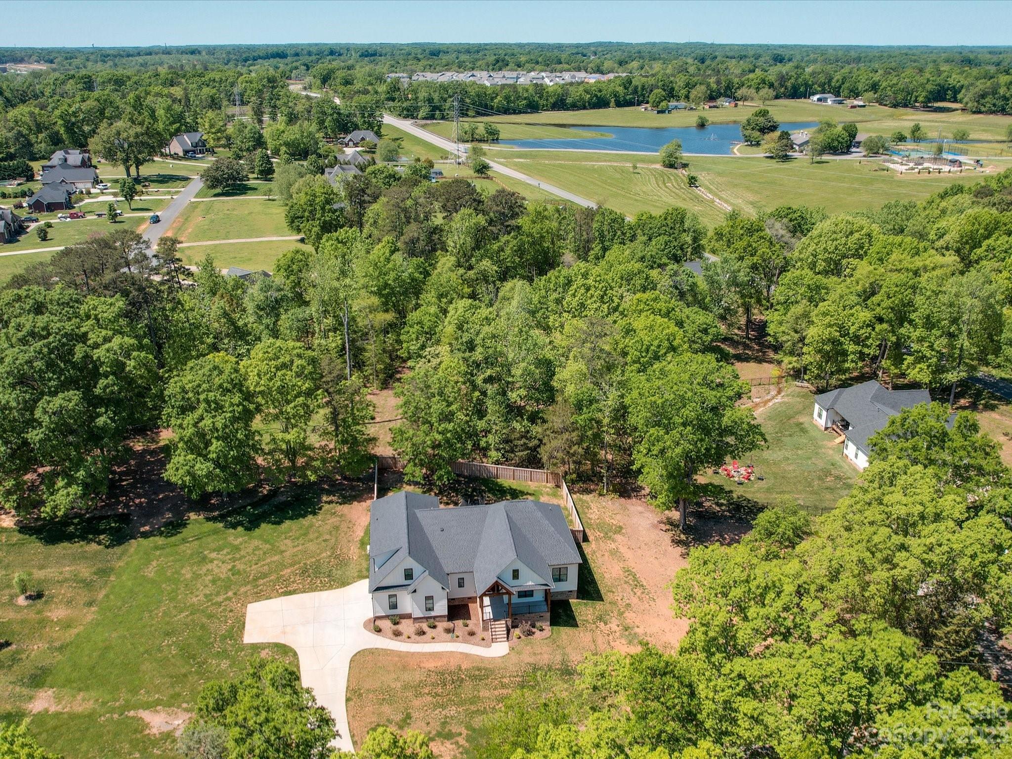 626 Deese Road Monroe, NC 28110 - Photo 7 of 41 an aerial view of a house with a yard and lake view