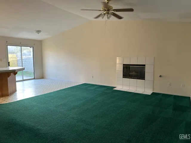 a view of a hardwood floor and a ceiling fan in a room