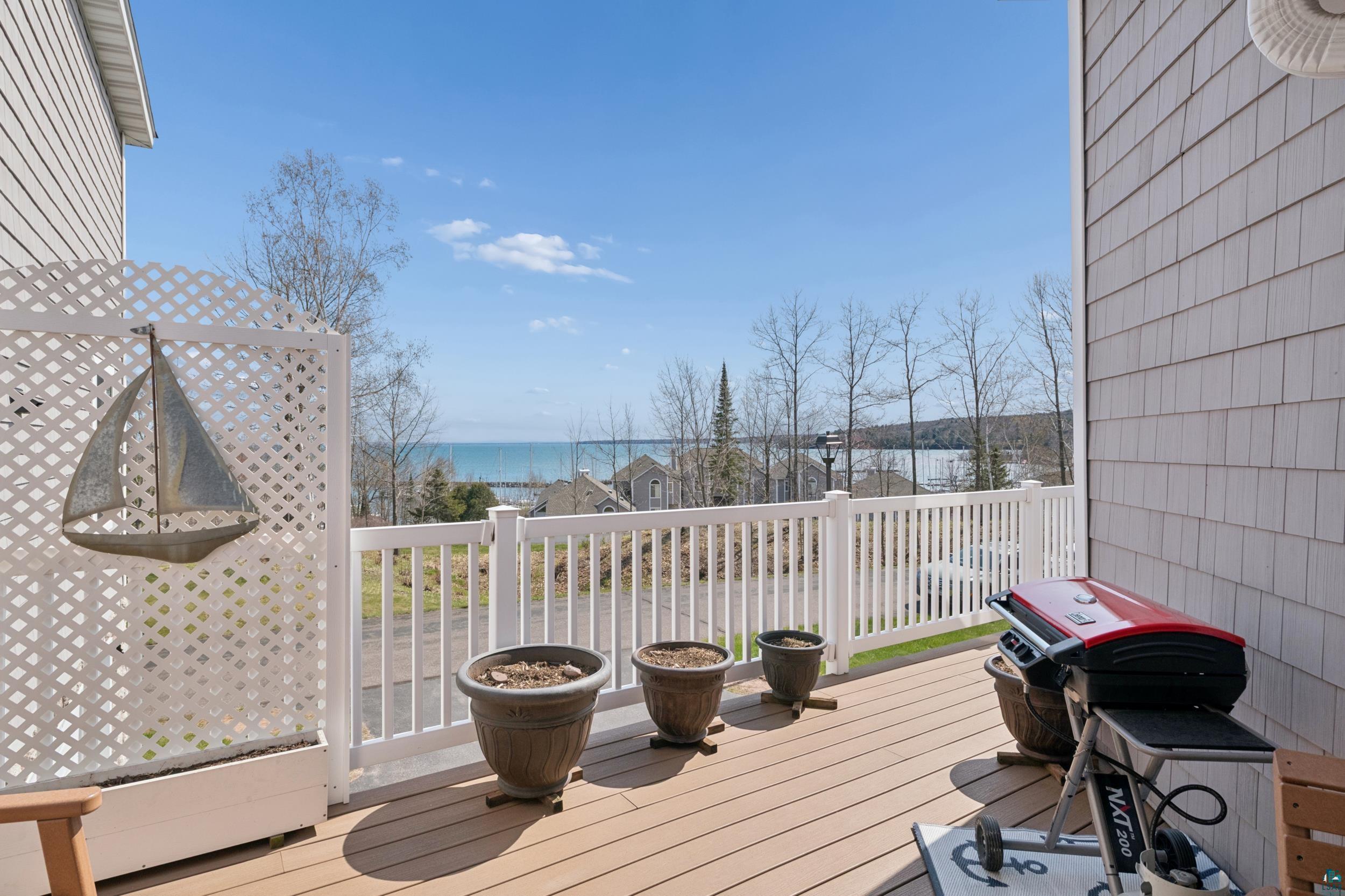 34590 Bay View Road, Unit 801 Bayfield, WI 54814 - Photo 2 of 36 Composite wood-finish decking with white railings and lattice privacy screen