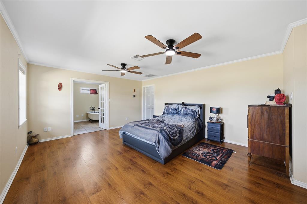 12985 County Road 4331 Larue, TX 75770 - Photo 13 of 23 a spacious bedroom with a bed and a ceiling fan