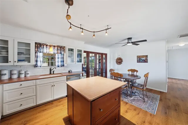 a view of a kitchen area with furniture and wooden floor