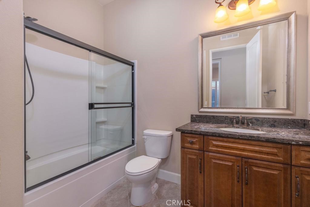 1647 Via Rojas Hemet, CA 92545 - Photo 12 of 29 a bathroom with a granite countertop sink toilet and shower